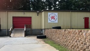 Front of gym building with sign